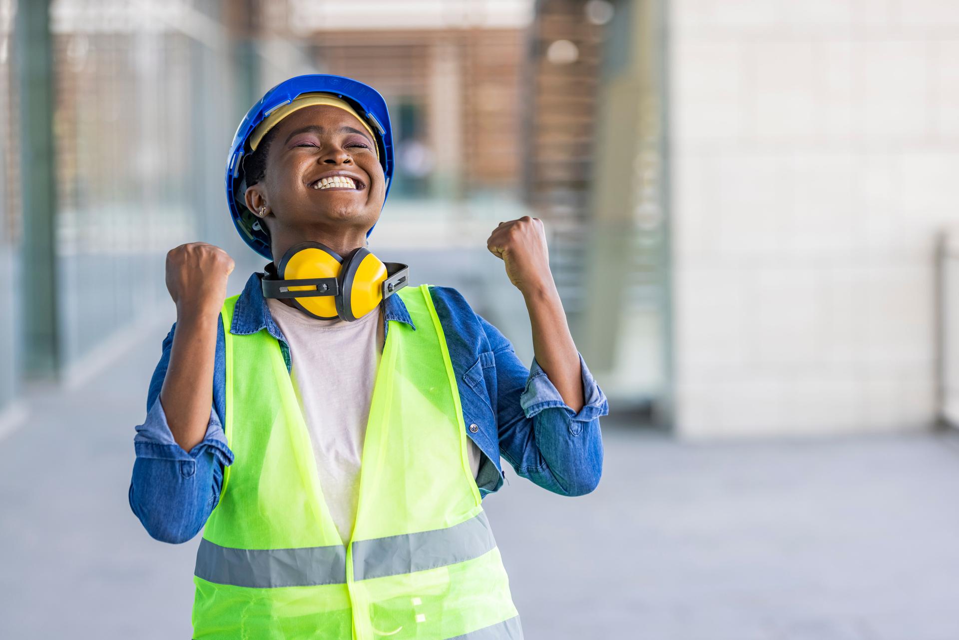 Young african american architect woman wearing security helmet very happy and excited doing winner gesture